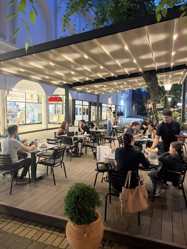 The garden under the pergola in the pedestrian zone, in the evening