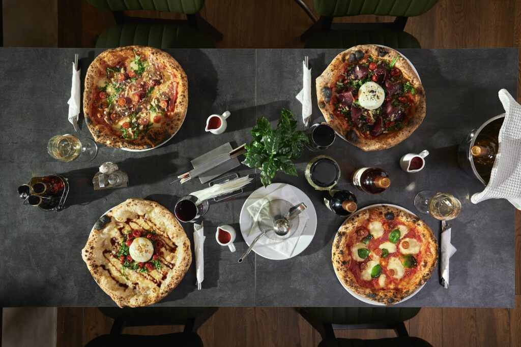 A table full of Neapolitan pizzas at Fabrika restaurant